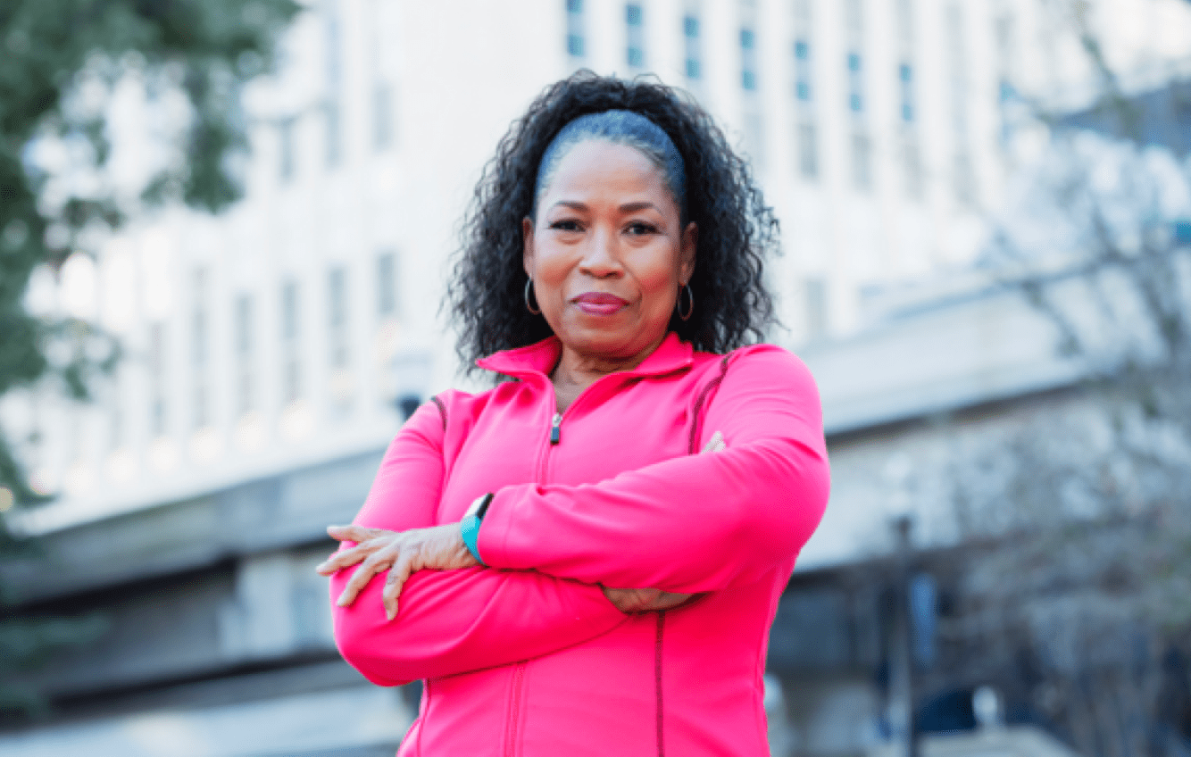 Women standing with building as backdrop